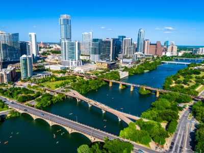 Kayakers ensuing the blue waters of Lady Bird Lake Aerial Austin Texas 2019 summer view above west Austin looking at new skyline cityscape skyscrapers